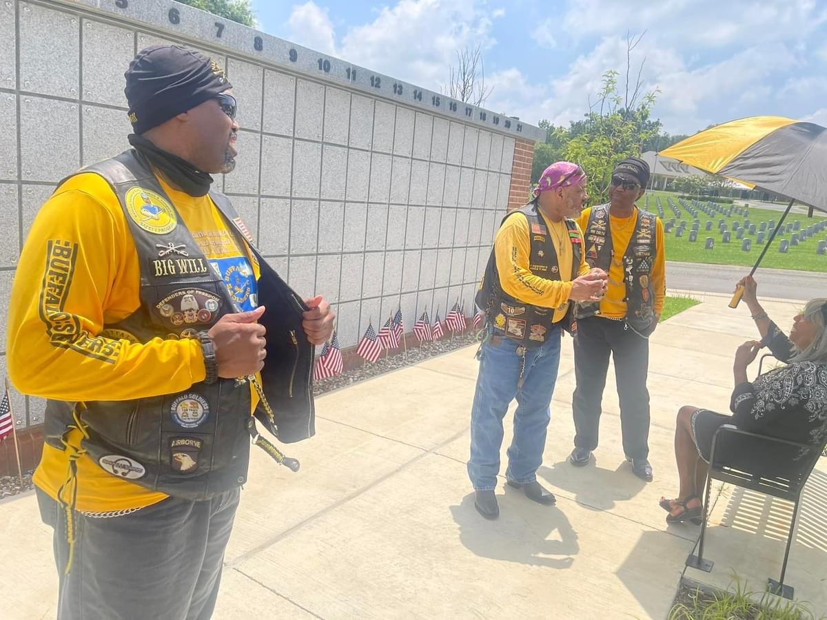 Buffalo Soldiers members at outdoor Memorial Day ceremony at veterans cemetery